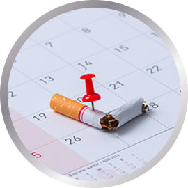 Cigarette snapped with pin on calendar date