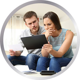 Couple looking at life mortgage policy on tablet